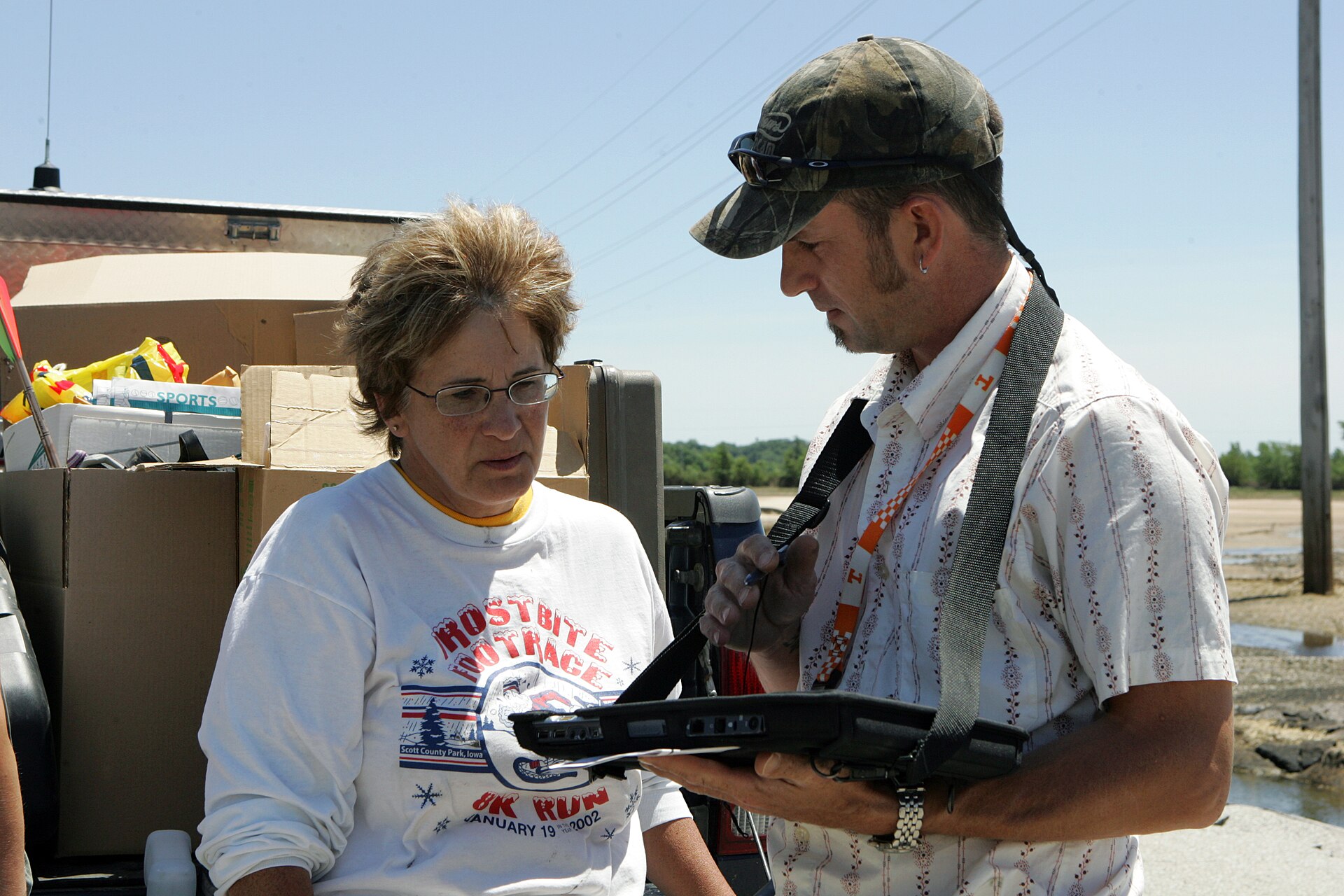 FEMA housing inspector speaking with an Iowa resident outside her home